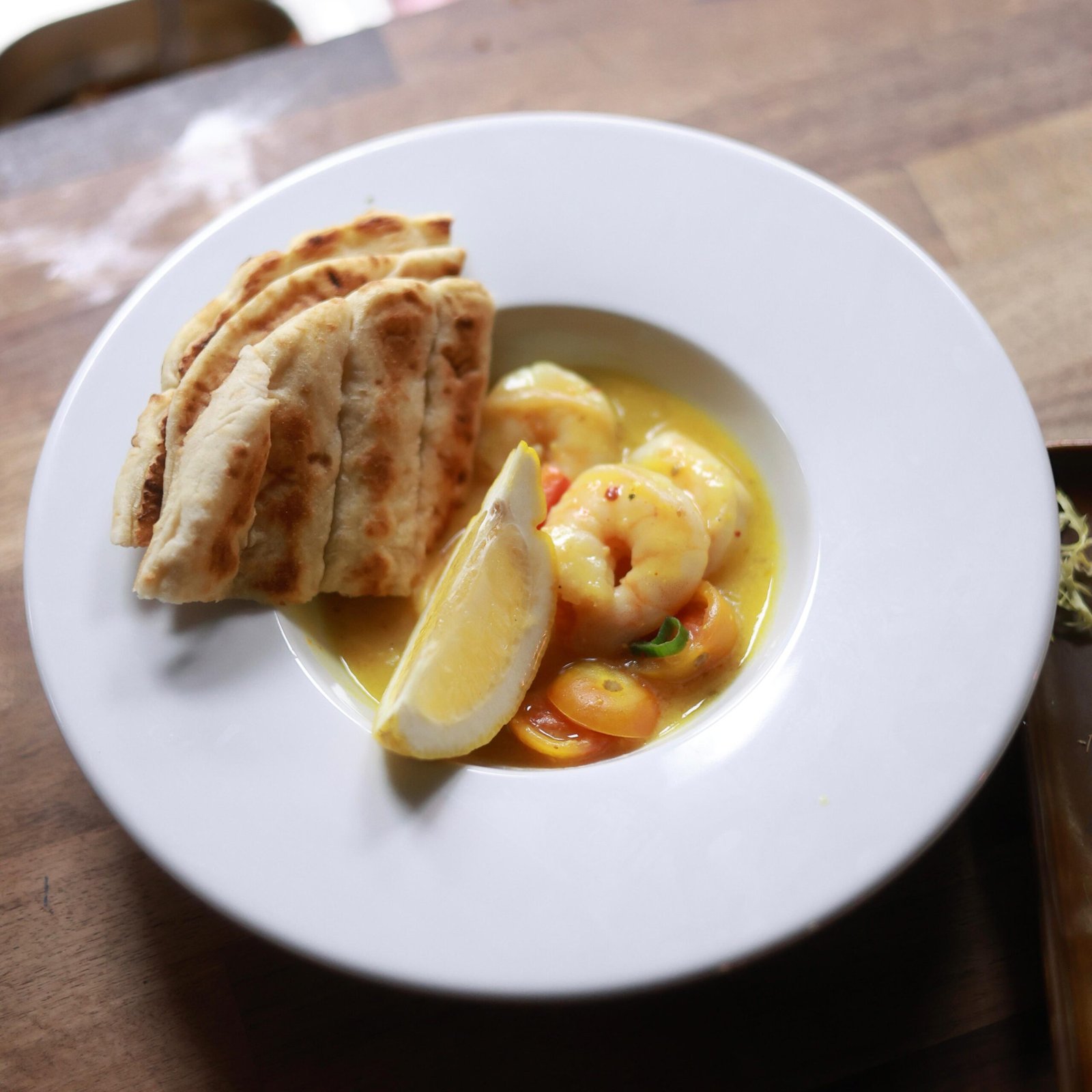 Garlic king prawns cooked in butter, lemon and white wine served with pitta bread
