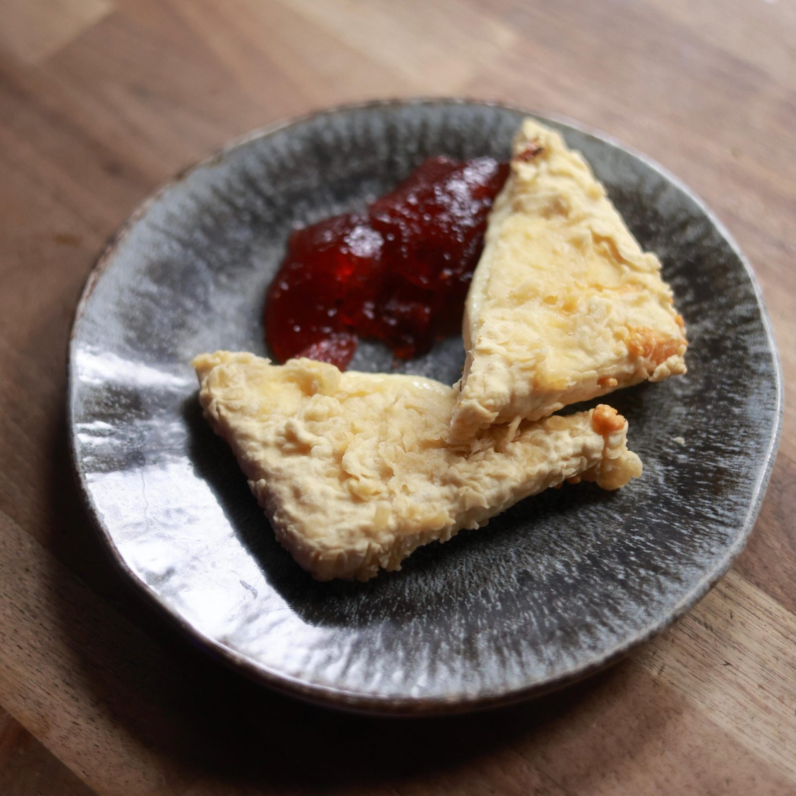 Fried graviera saganaki cheese served with cherry jam and lemon