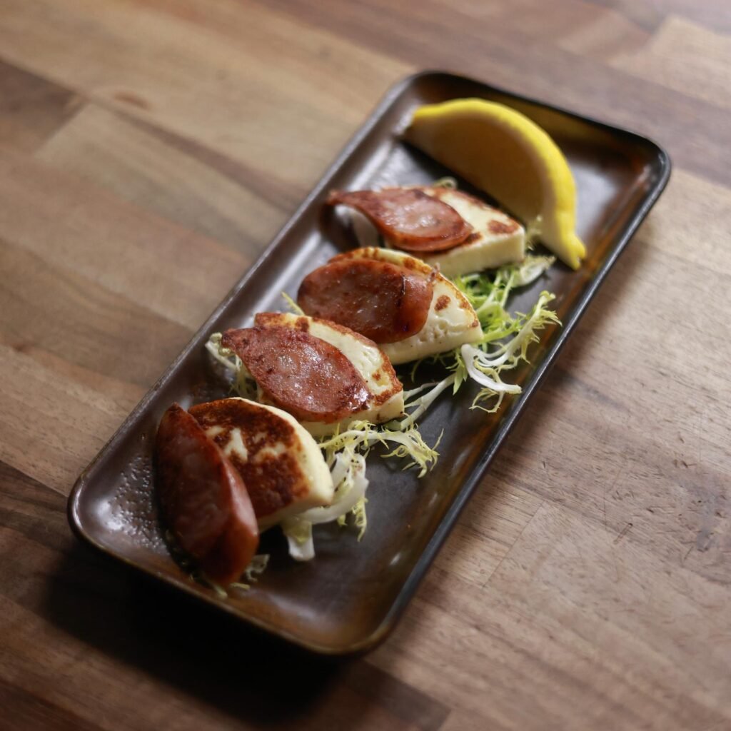 Grilled halloumi with sliced Greek loukaniko sausage served with lemon